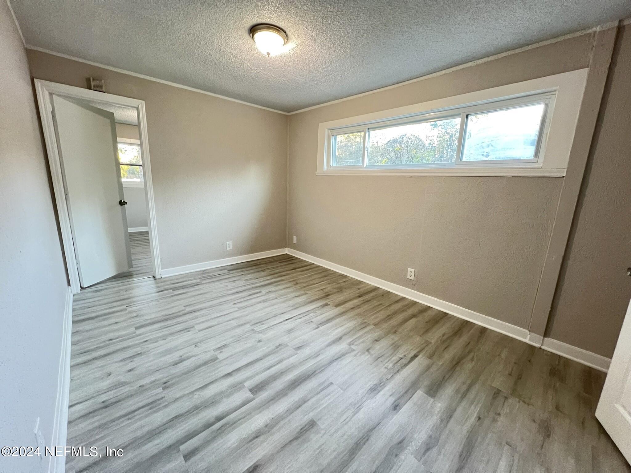 2704 Forman Circle Middleburg, FL 32068 - Photo 5 of 14 an empty room with wooden floor and windows
