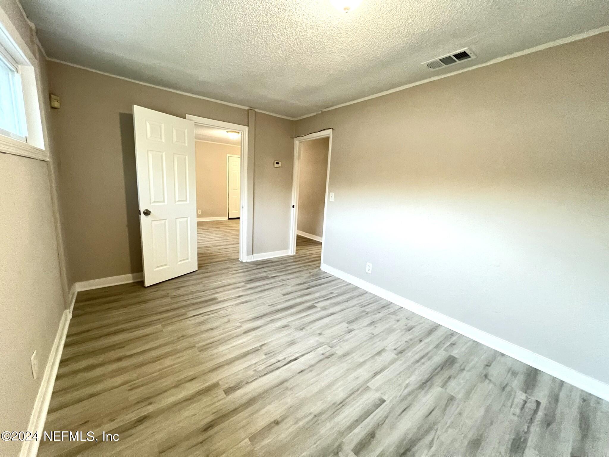 2704 Forman Circle Middleburg, FL 32068 - Photo 6 of 14 a view of an empty room with wooden floor and a window