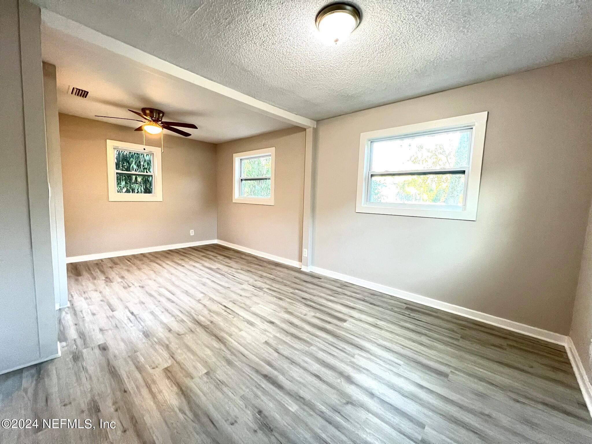 2704 Forman Circle Middleburg, FL 32068 - Photo 7 of 14 a view of an empty room with wooden floor and a window