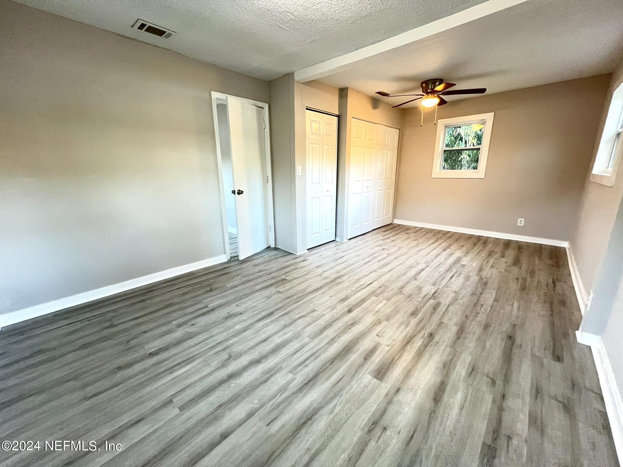 2704 Forman Circle Middleburg, FL 32068 - Photo 8 of 14 an empty room with wooden floor and windows