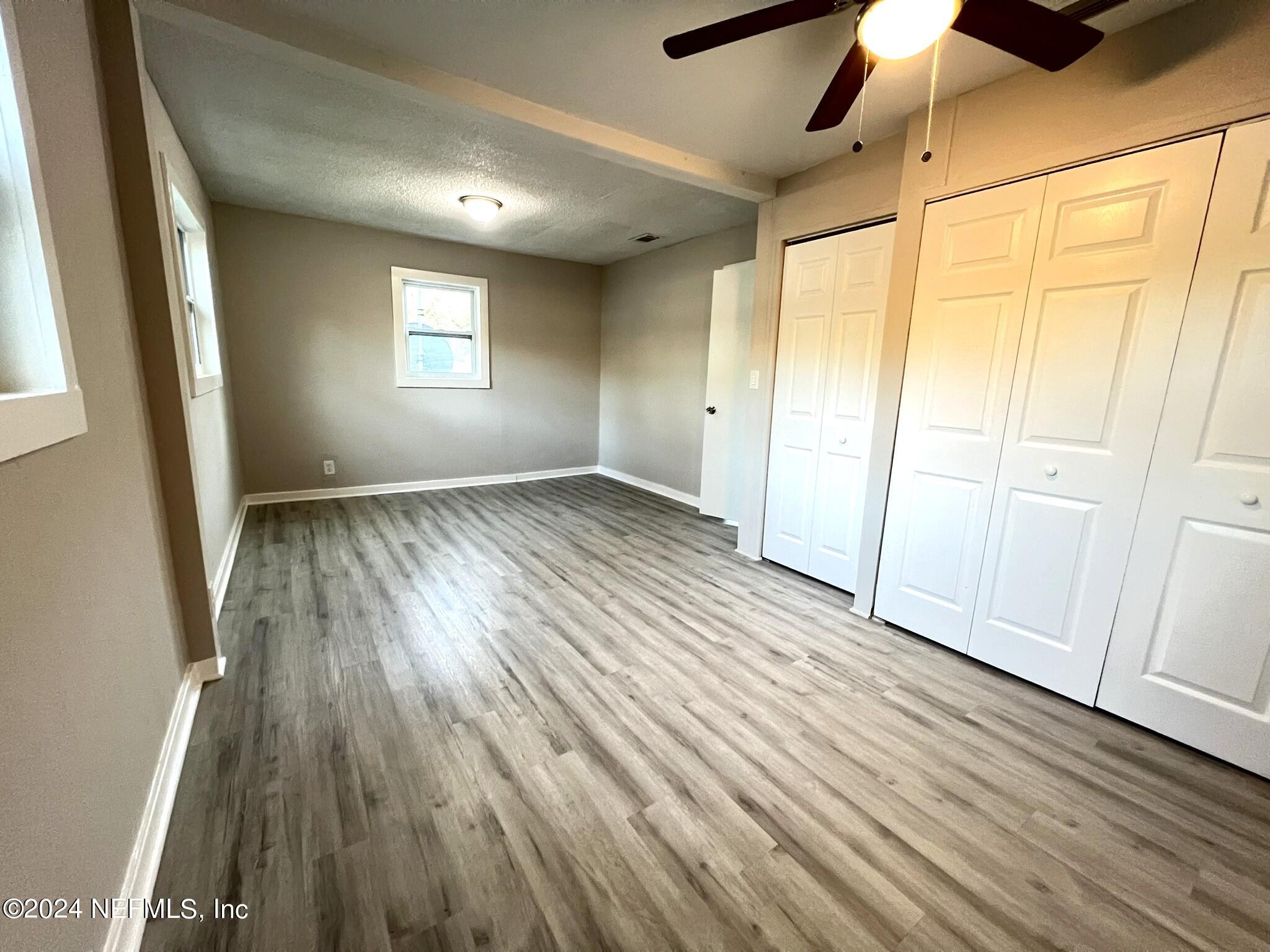 2704 Forman Circle Middleburg, FL 32068 - Photo 9 of 14 an empty room with wooden floor and windows