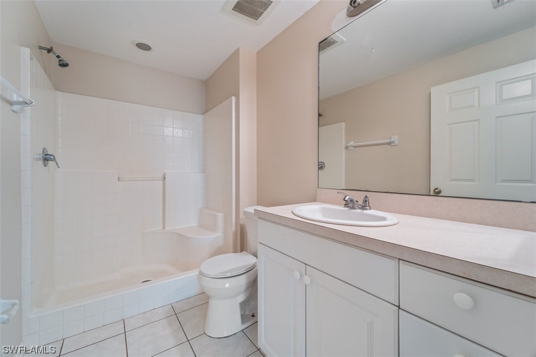 1325 Reflections Way, Unit 521 Immokalee, FL 34142 - Photo 13 of 17 a bathroom with a sink a toilet and shower