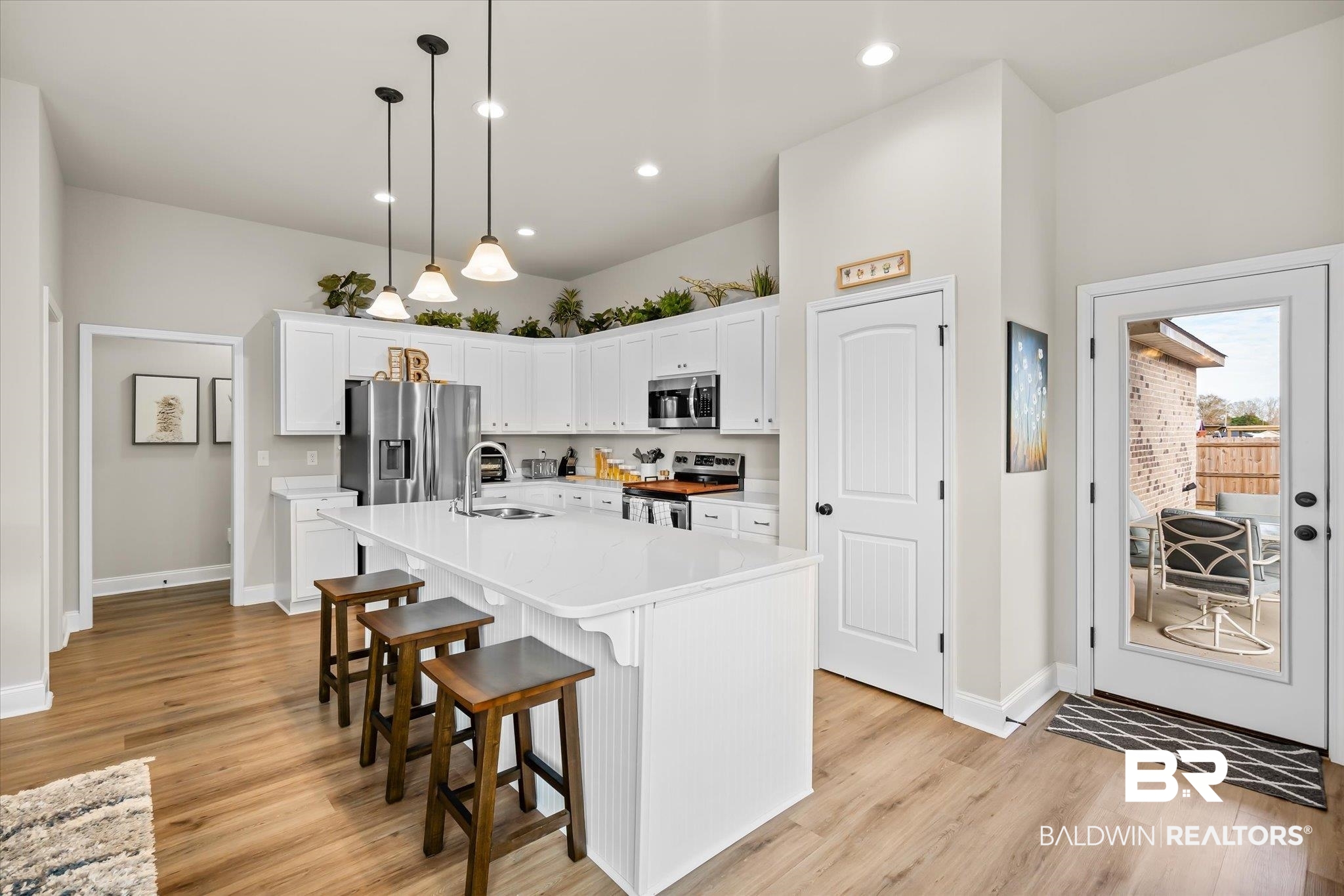 1116 Stella Road Foley, AL 36535 - Photo 11 of 29 Kitchen featuring sink, white cabinets, a center island with sink, pendant lighting, and appliances with stainless steel finishes
