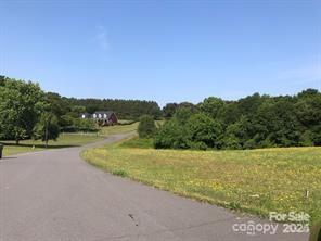 1013 Point Crossing Court, Unit 25 Shelby, NC 28152 - Photo 1 of 9 a view of a lake with houses in the back
