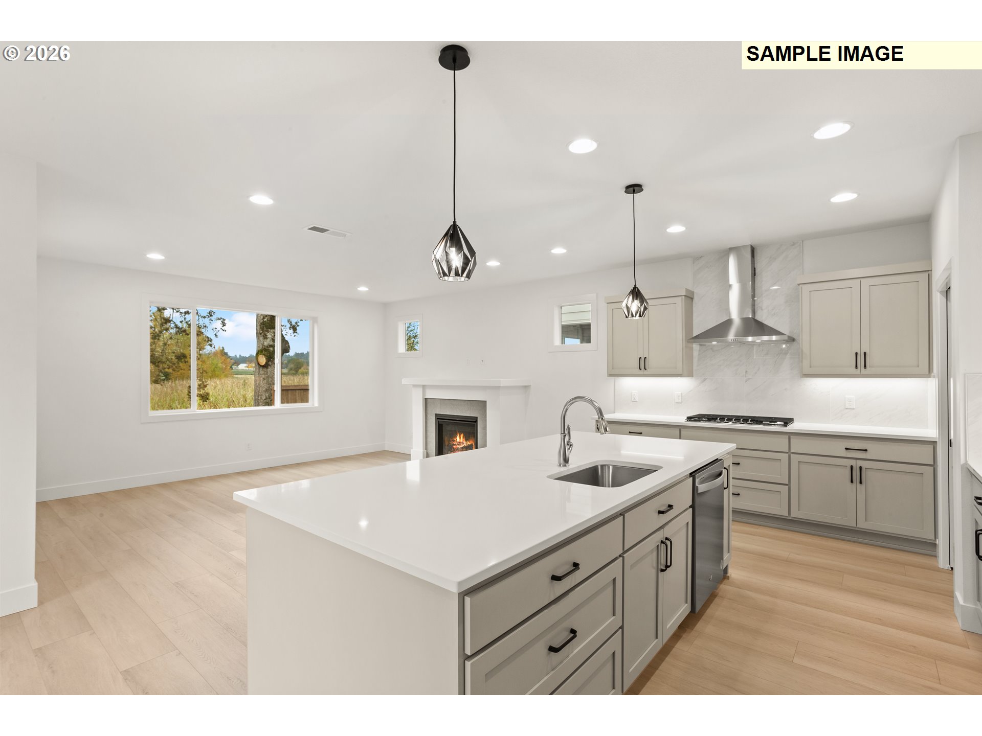 7283 Southwest Frog Pond Lane Wilsonville, OR 97070 - Photo 11 of 33 a kitchen with kitchen island a sink stainless steel appliances and cabinets