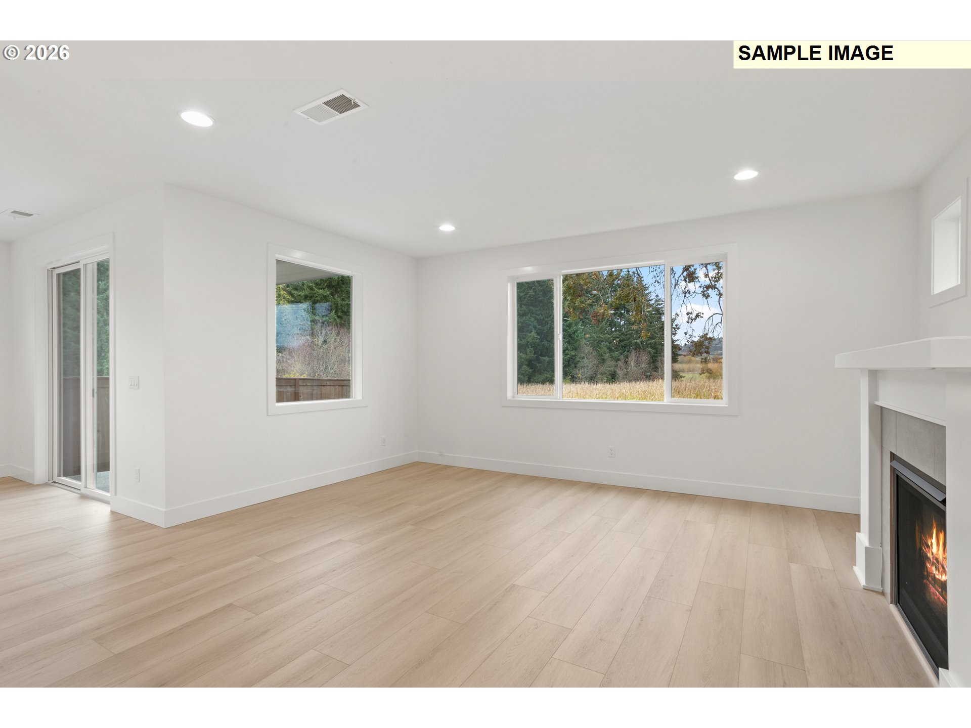 7283 Southwest Frog Pond Lane Wilsonville, OR 97070 - Photo 15 of 33 a view of an empty room with a window and wooden floor