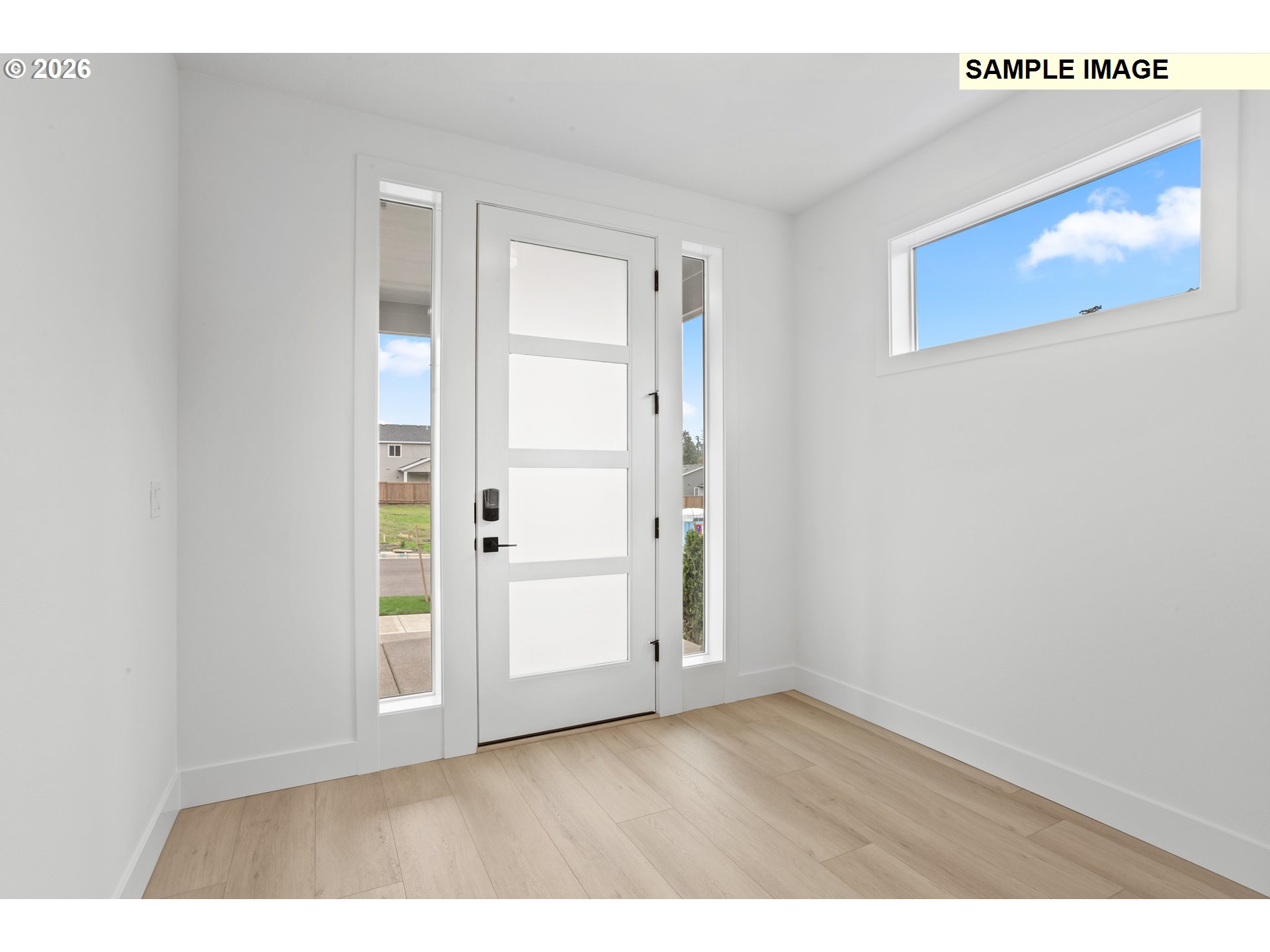 7283 Southwest Frog Pond Lane Wilsonville, OR 97070 - Photo 4 of 33 a view of an empty room with wooden floor
