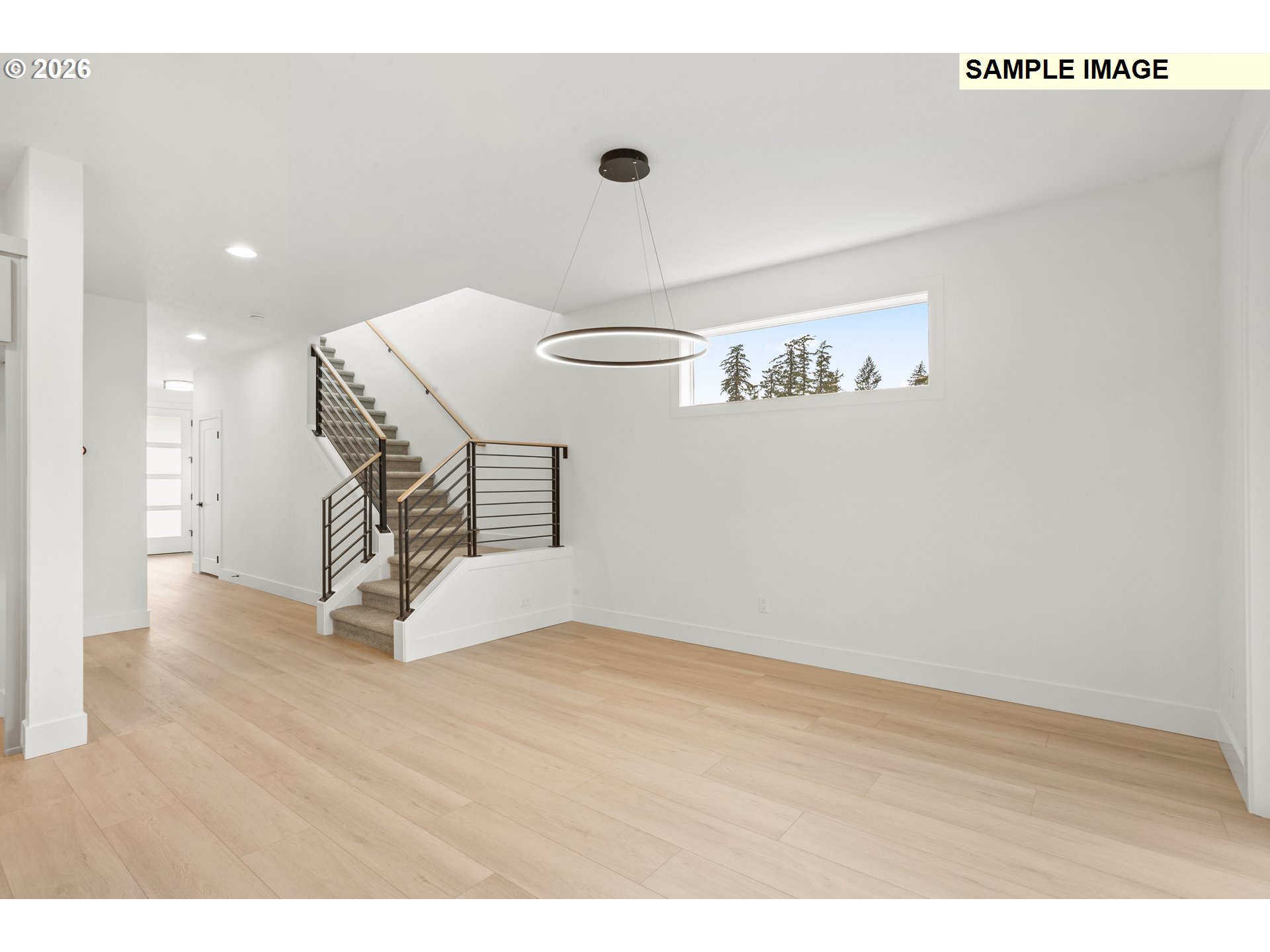 7283 Southwest Frog Pond Lane Wilsonville, OR 97070 - Photo 9 of 33 a view of an empty room with wooden floor