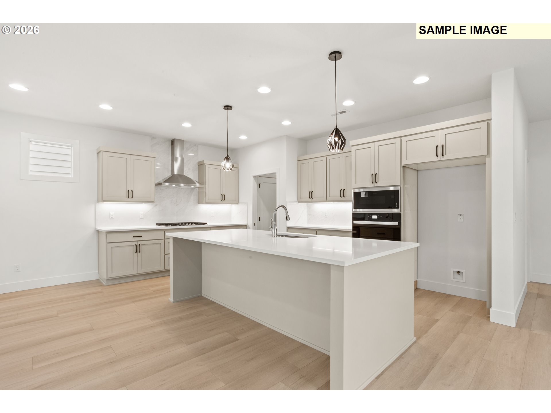 7283 Southwest Frog Pond Lane Wilsonville, OR 97070 - Photo 10 of 33 a kitchen with white cabinets appliances and wooden floor