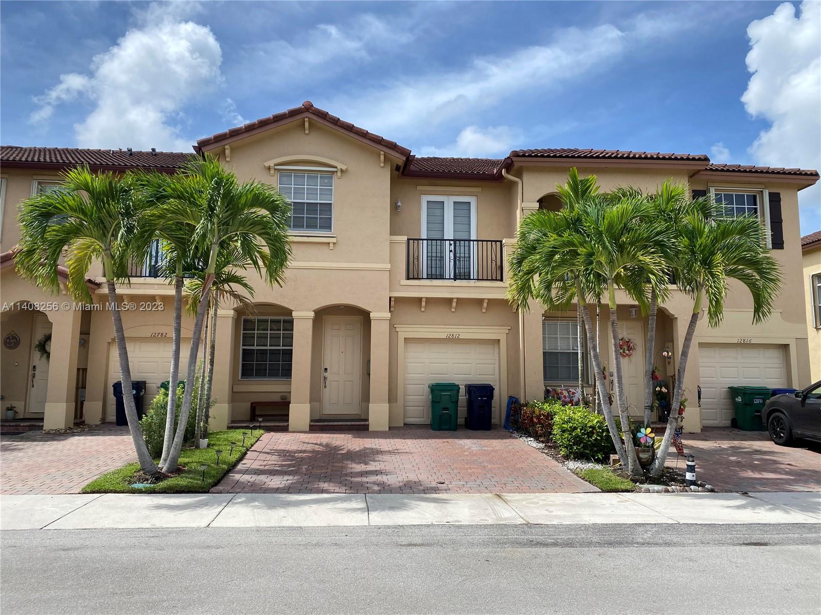 12812 Southwest 134th Terrace Miami, FL 33186 - Photo 1 of 41 a front view of a house with a garden