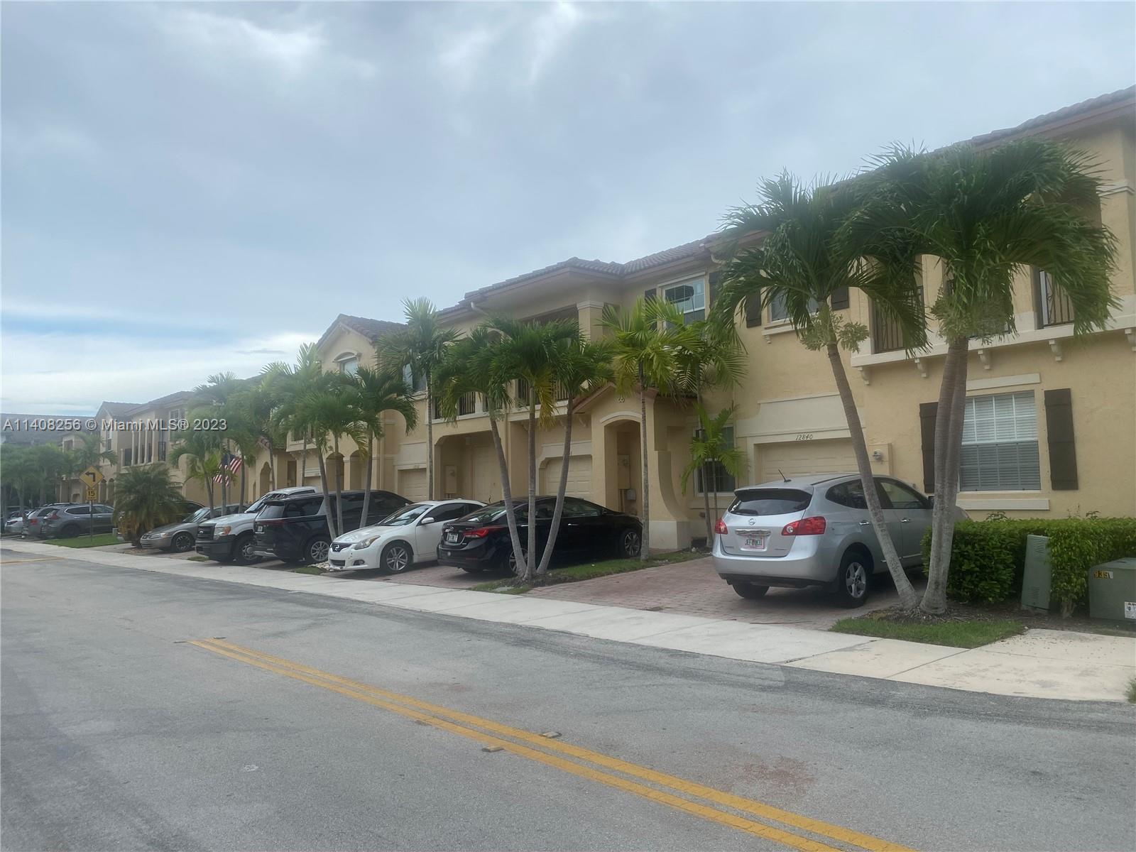 12812 Southwest 134th Terrace Miami, FL 33186 - Photo 2 of 41 a couple of cars parked in front of a building