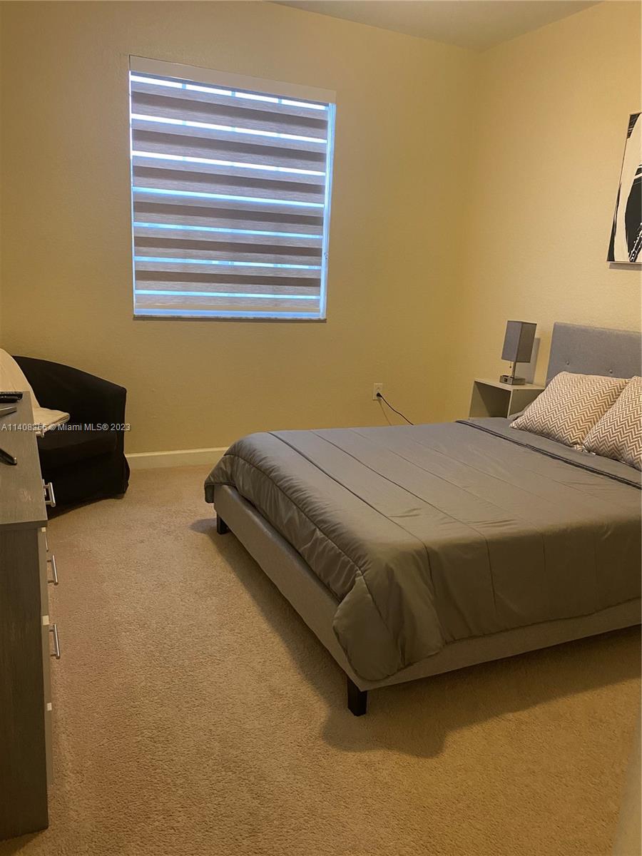 12812 Southwest 134th Terrace Miami, FL 33186 - Photo 22 of 41 a bedroom with a bed and dresser