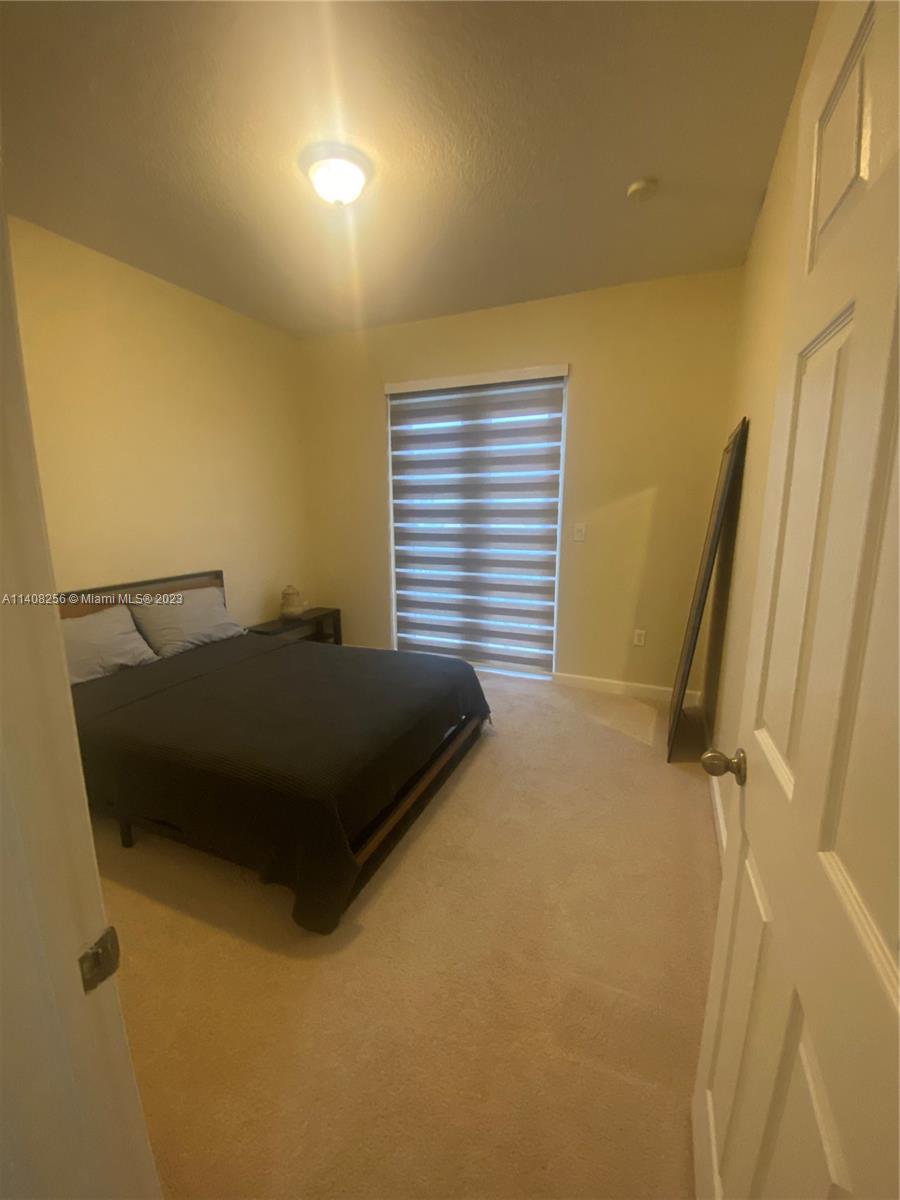 12812 Southwest 134th Terrace Miami, FL 33186 - Photo 24 of 41 a bedroom with a bed and a window
