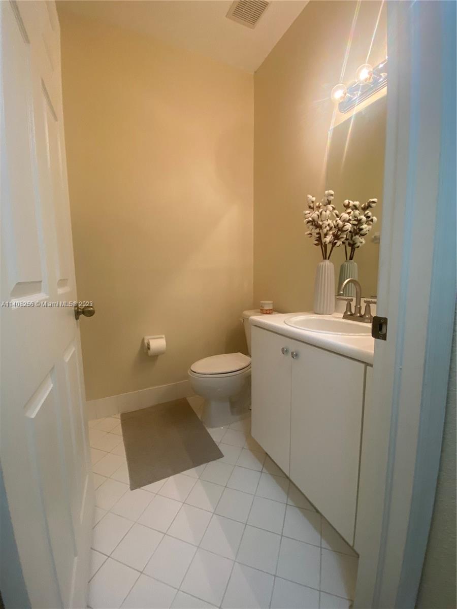 12812 Southwest 134th Terrace Miami, FL 33186 - Photo 7 of 41 a bathroom with a sink and mirror with toilet