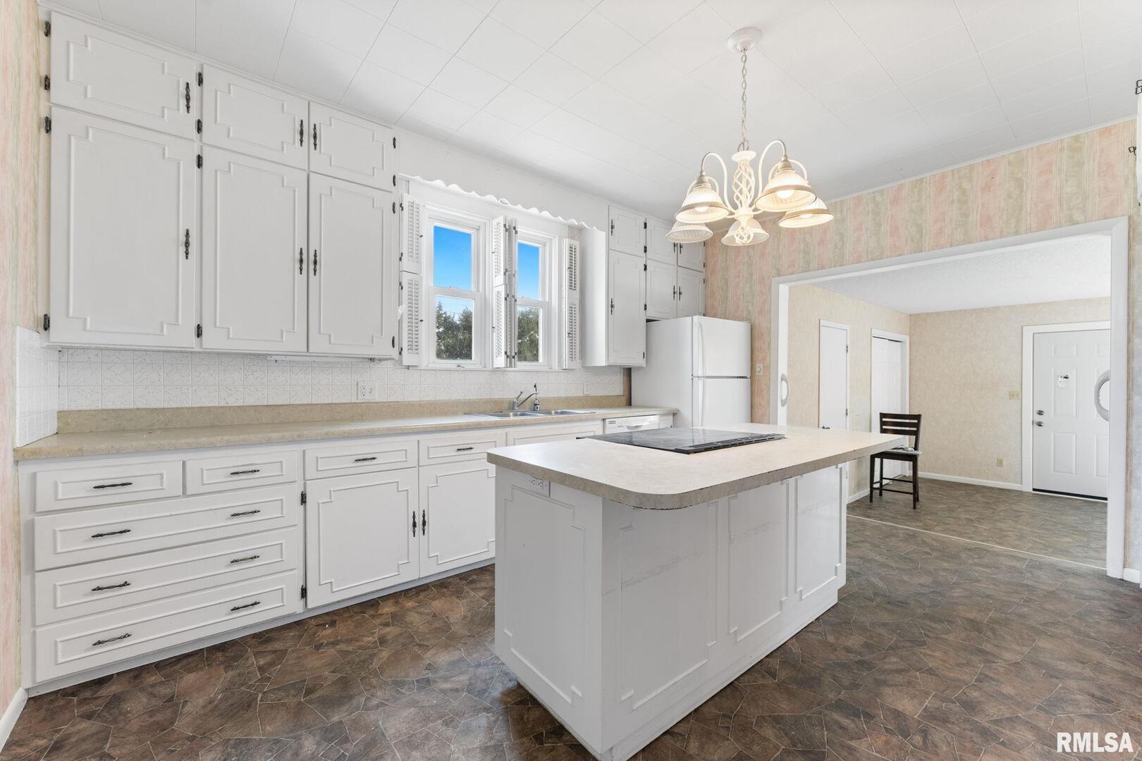 2442 Mittman Road Muscatine, IA 52761 - Photo 12 of 24 a kitchen that has a lot of white cabinets and stainless steel appliances