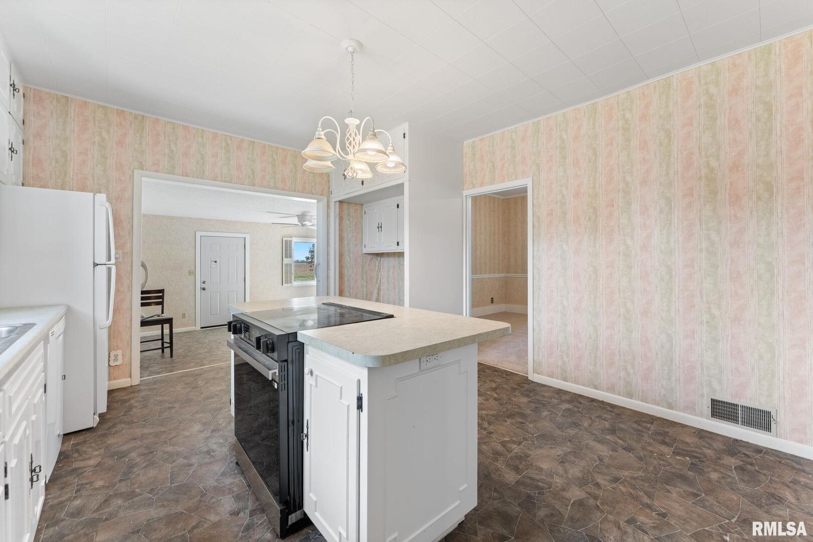 2442 Mittman Road Muscatine, IA 52761 - Photo 13 of 24 a kitchen that has a lot of cabinets in it