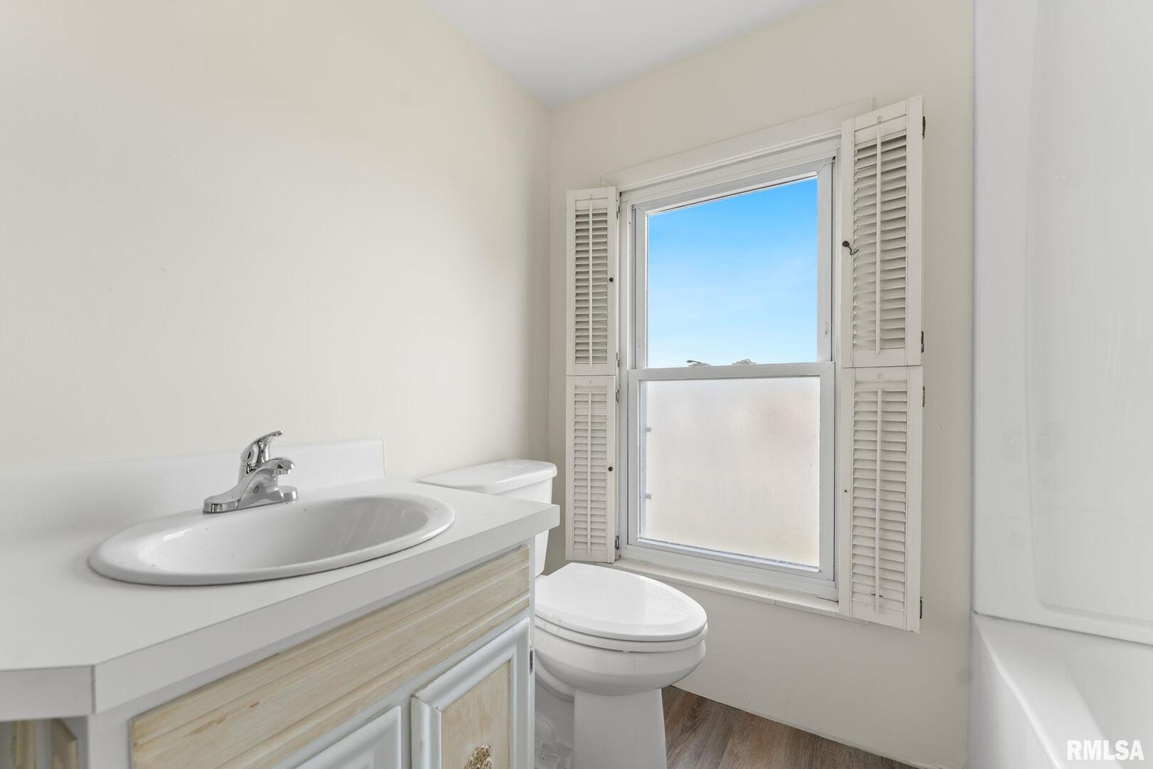 2442 Mittman Road Muscatine, IA 52761 - Photo 19 of 24 a bathroom with a sink a toilet and tub