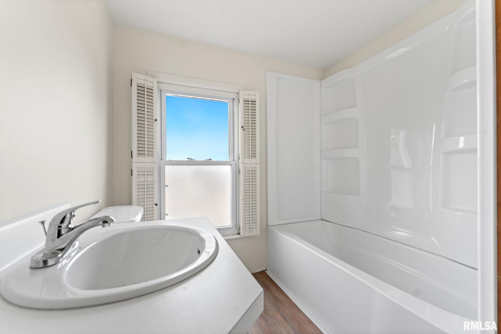 2442 Mittman Road Muscatine, IA 52761 - Photo 20 of 24 a bathroom with a sink and a bathtub