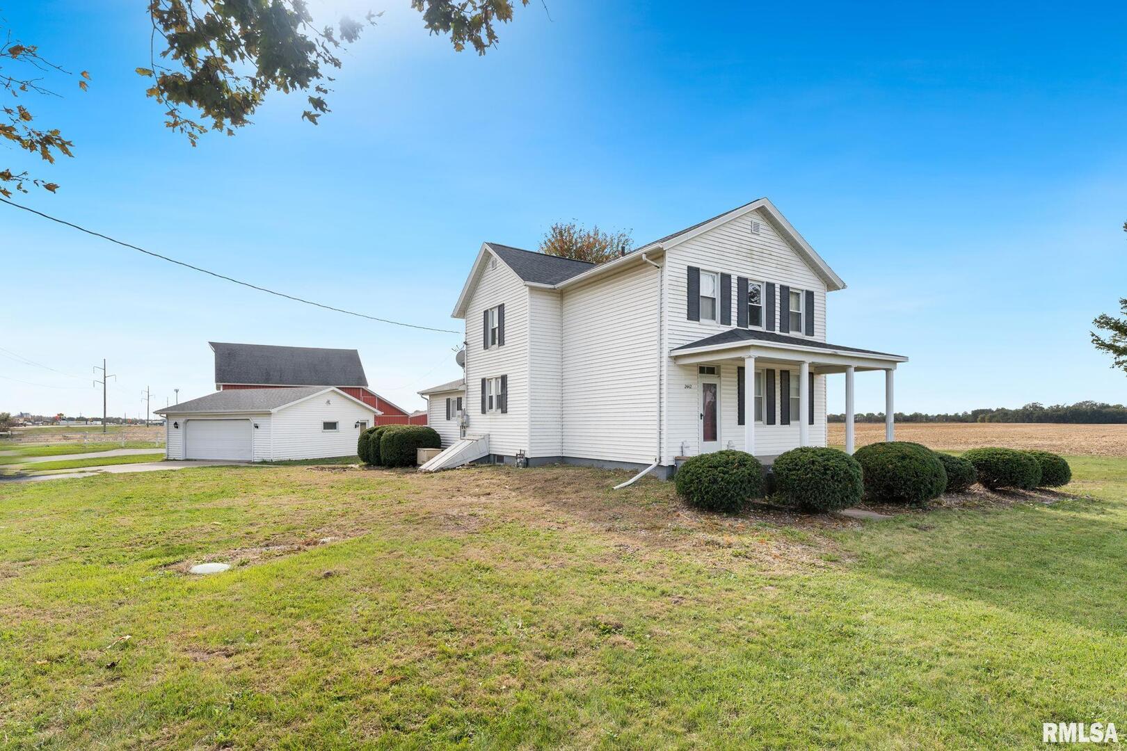 2442 Mittman Road Muscatine, IA 52761 - Photo 2 of 24 a front view of a house with a garden