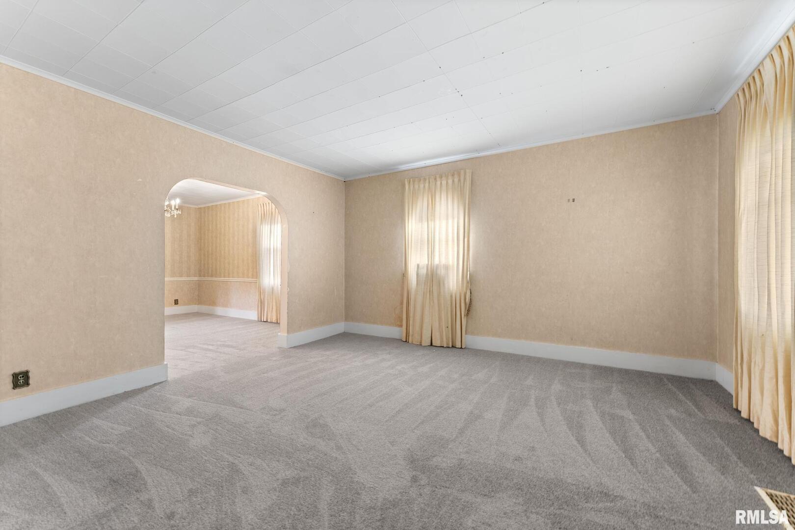 2442 Mittman Road Muscatine, IA 52761 - Photo 7 of 24 an empty room with a window and a mirror