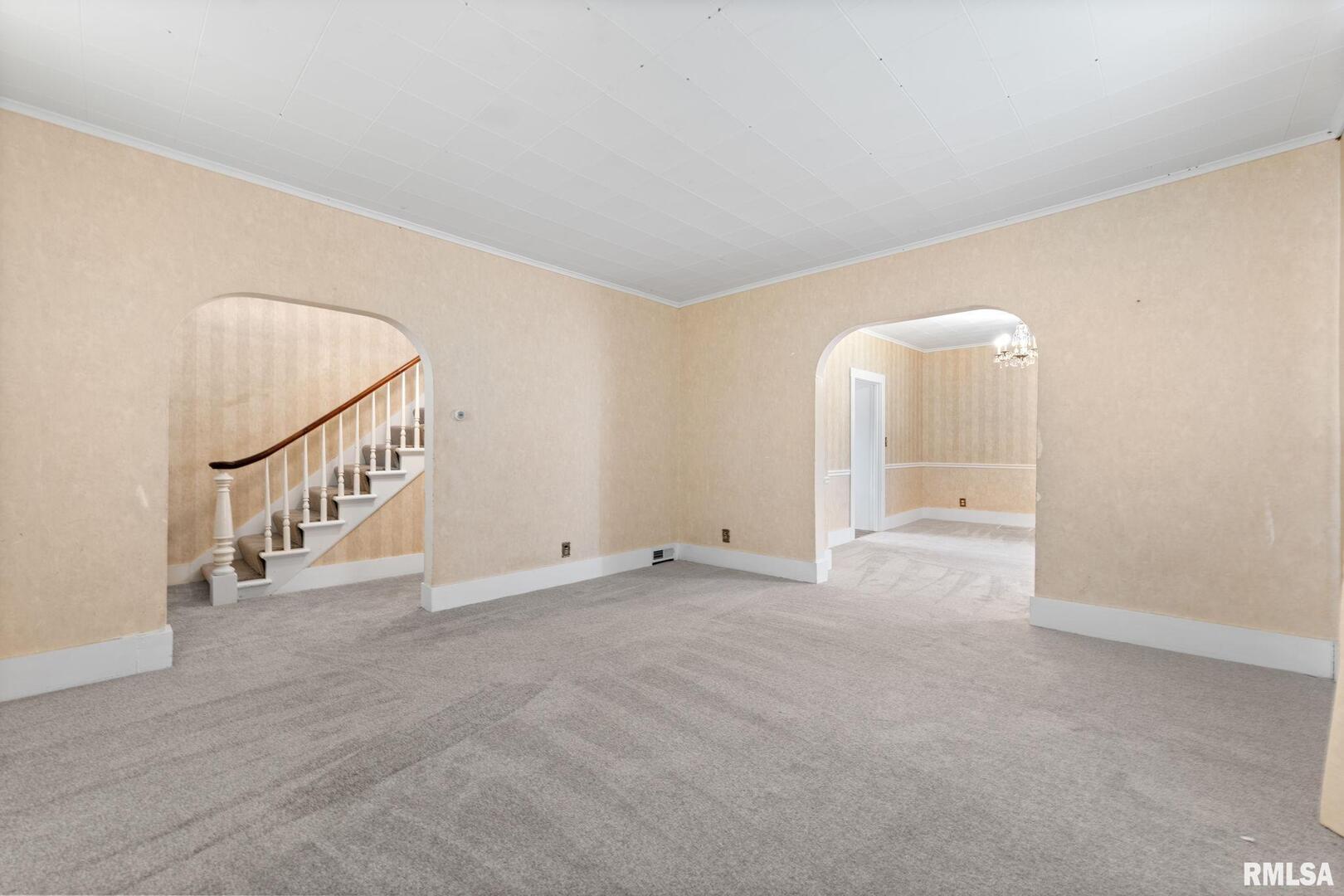 2442 Mittman Road Muscatine, IA 52761 - Photo 8 of 24 a view of an empty room with stairs and a window