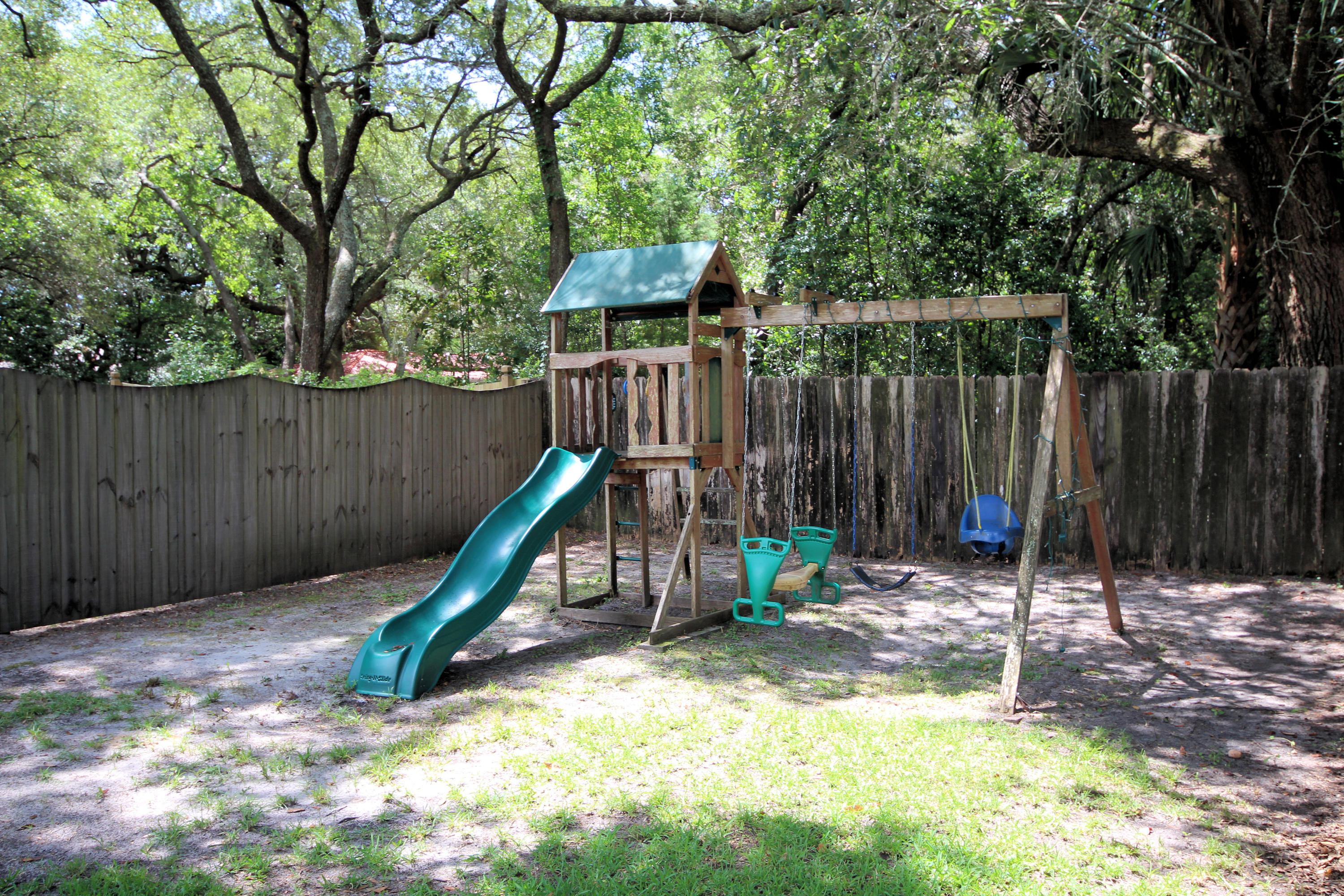 616 Lang Road Fort Walton Beach, FL 32547 - Photo 46 of 54 a view of a backyard with a slide and wooden fence