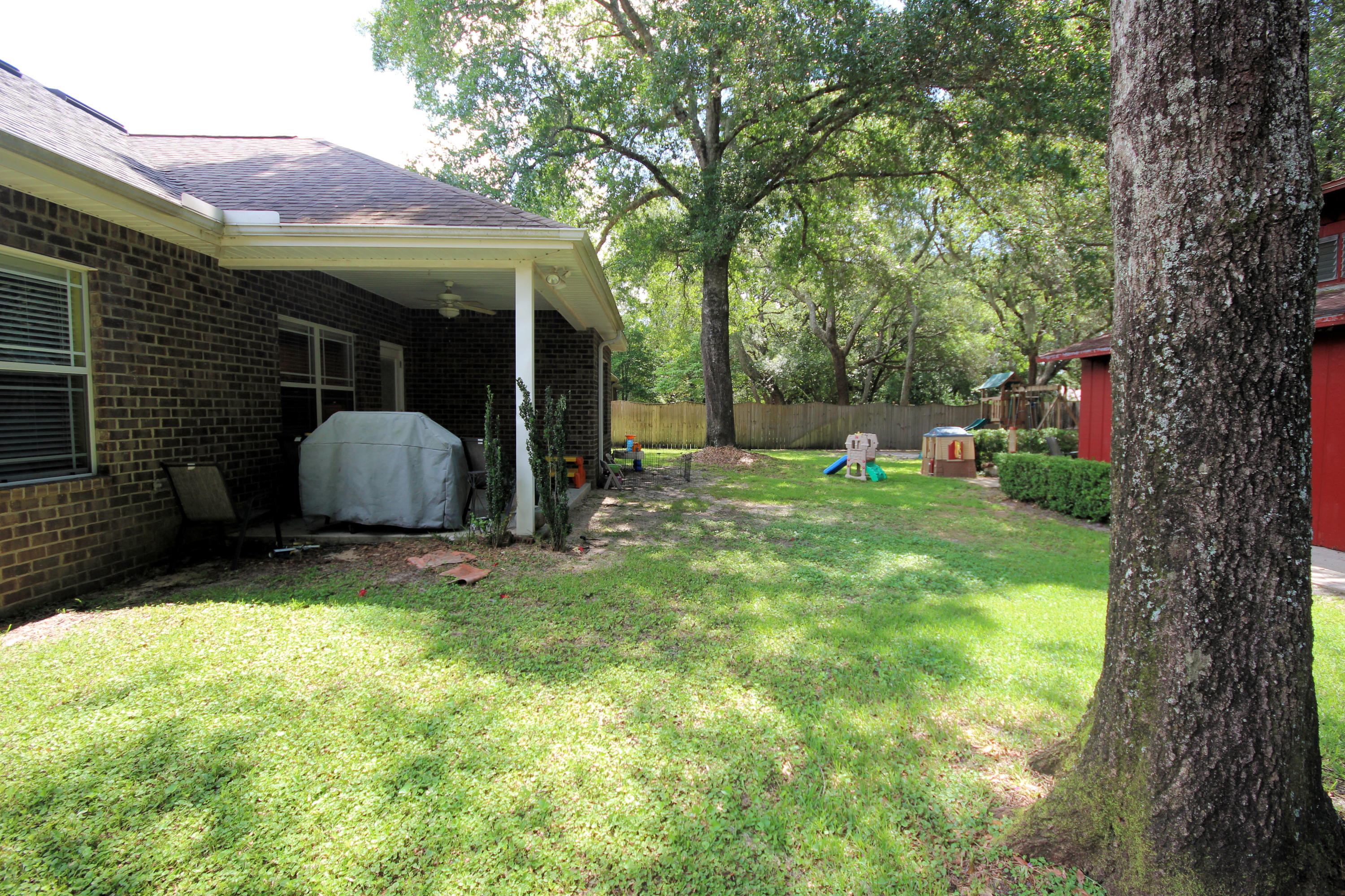 616 Lang Road Fort Walton Beach, FL 32547 - Photo 53 of 54 a view of a house with backyard and sitting area