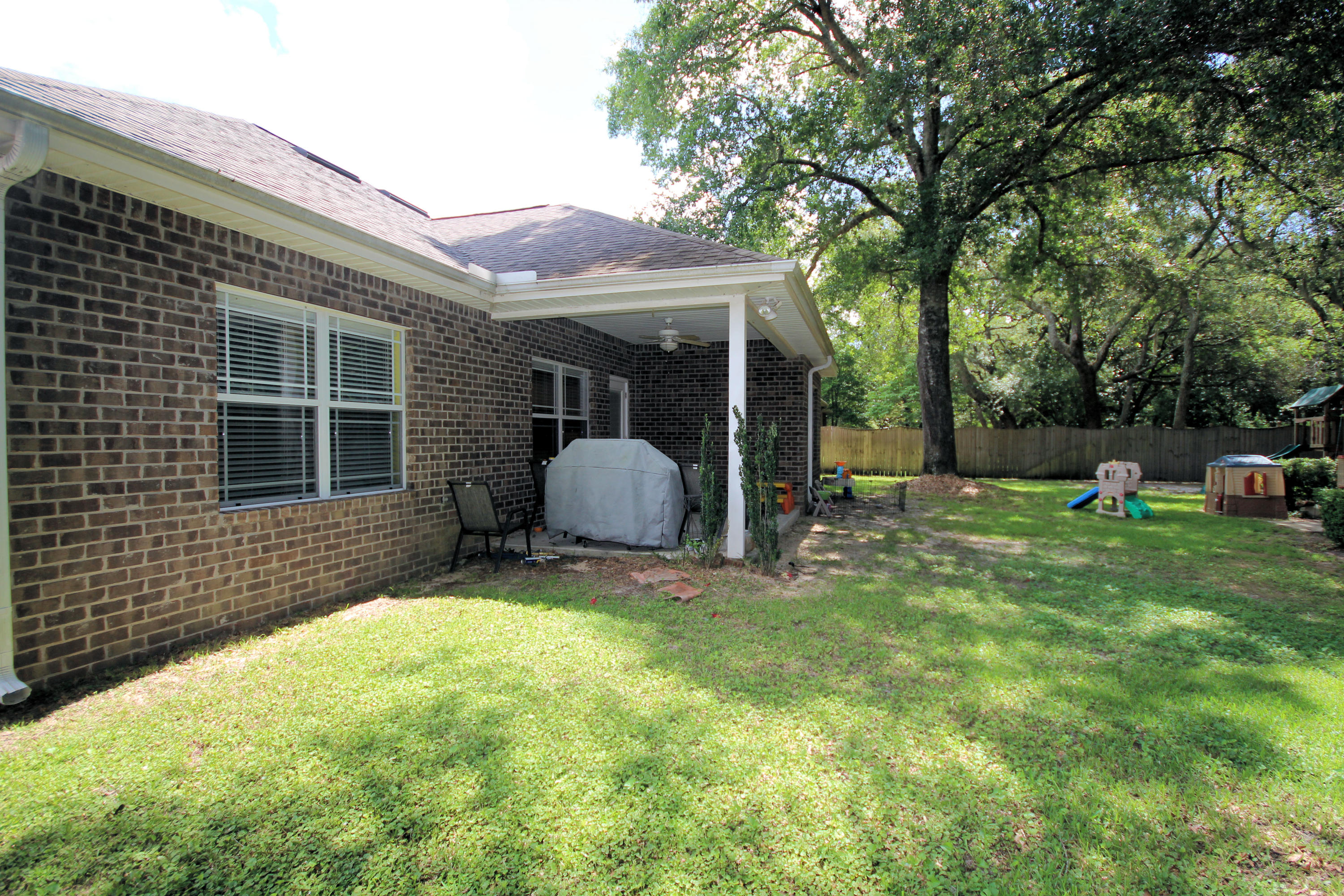 616 Lang Road Fort Walton Beach, FL 32547 - Photo 54 of 54 a view of a house with backyard and sitting area