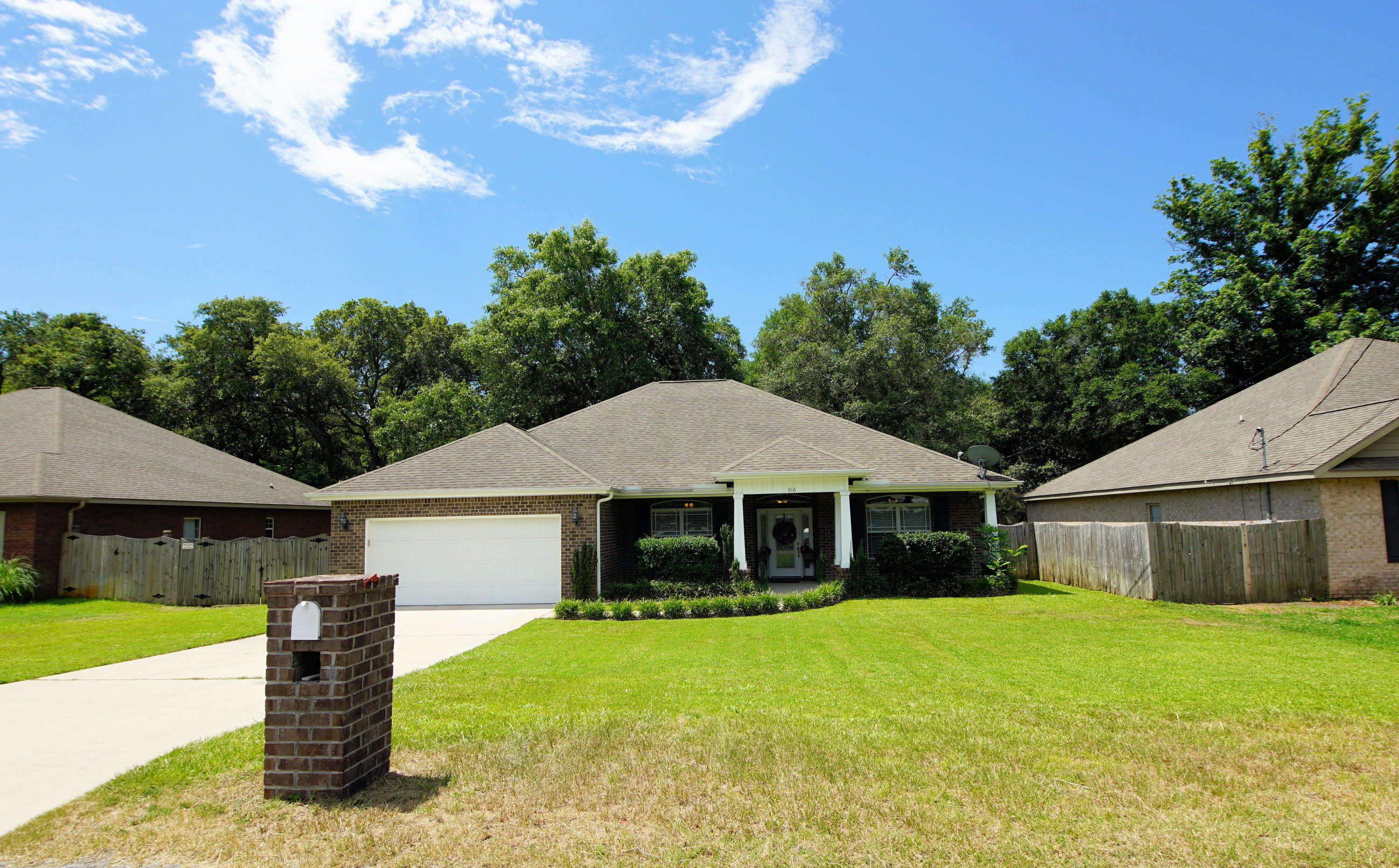 616 Lang Road Fort Walton Beach, FL 32547 - Photo 8 of 54 a front view of a house with a garden and yard
