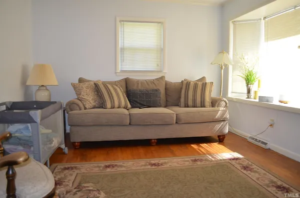 a living room with furniture and a lamp
