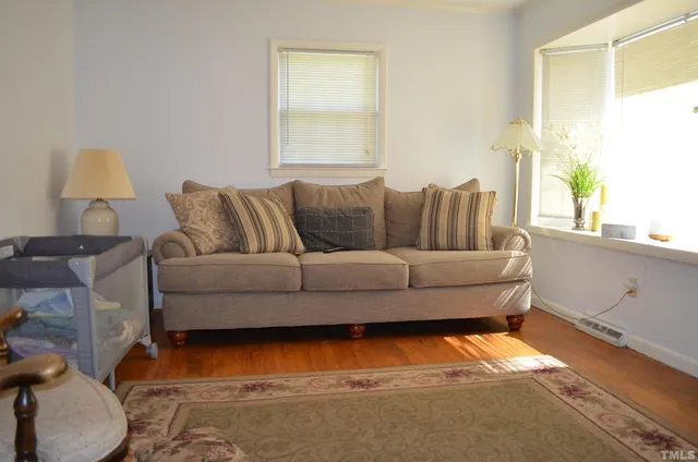 a living room with furniture and a lamp