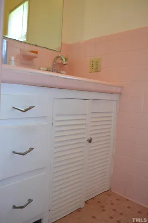 a room with a bed and dressers