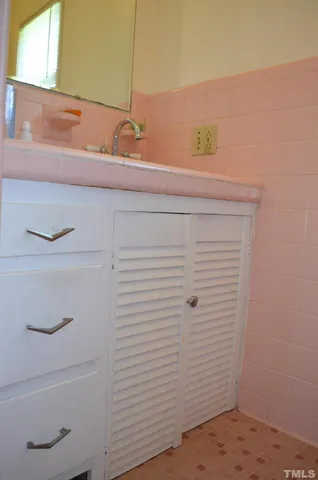 a room with a bed and dressers