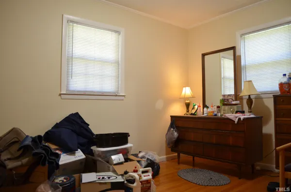 a living room with a bed and a window