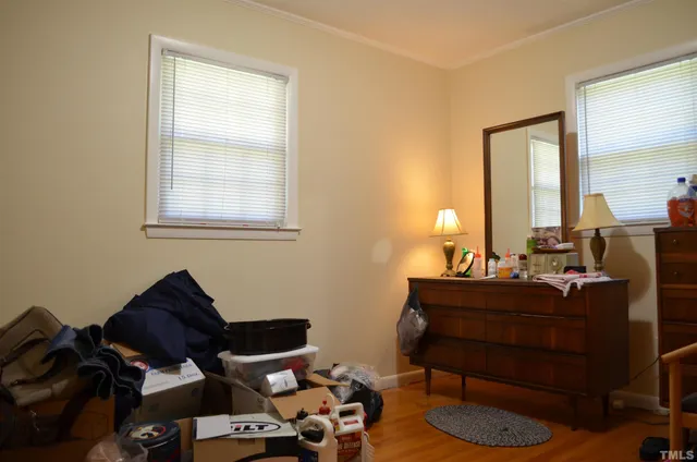 a living room with a bed and a window
