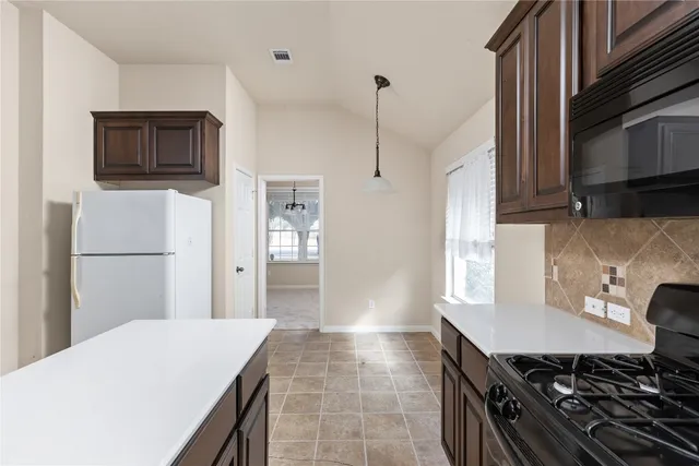 a kitchen with a stove and a refrigerator