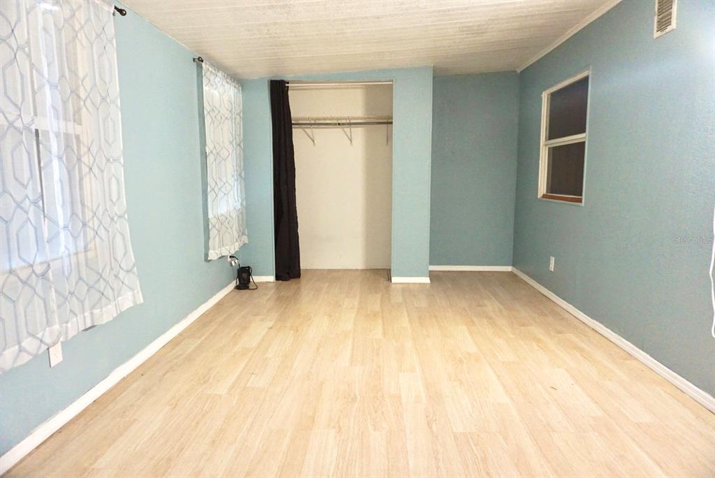 980 7th Street Northwest, Unit 71 Largo, FL 33770 - Photo 13 of 23 a bedroom with a bed and a window