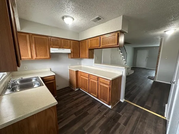 a kitchen that has a sink and a stove in it