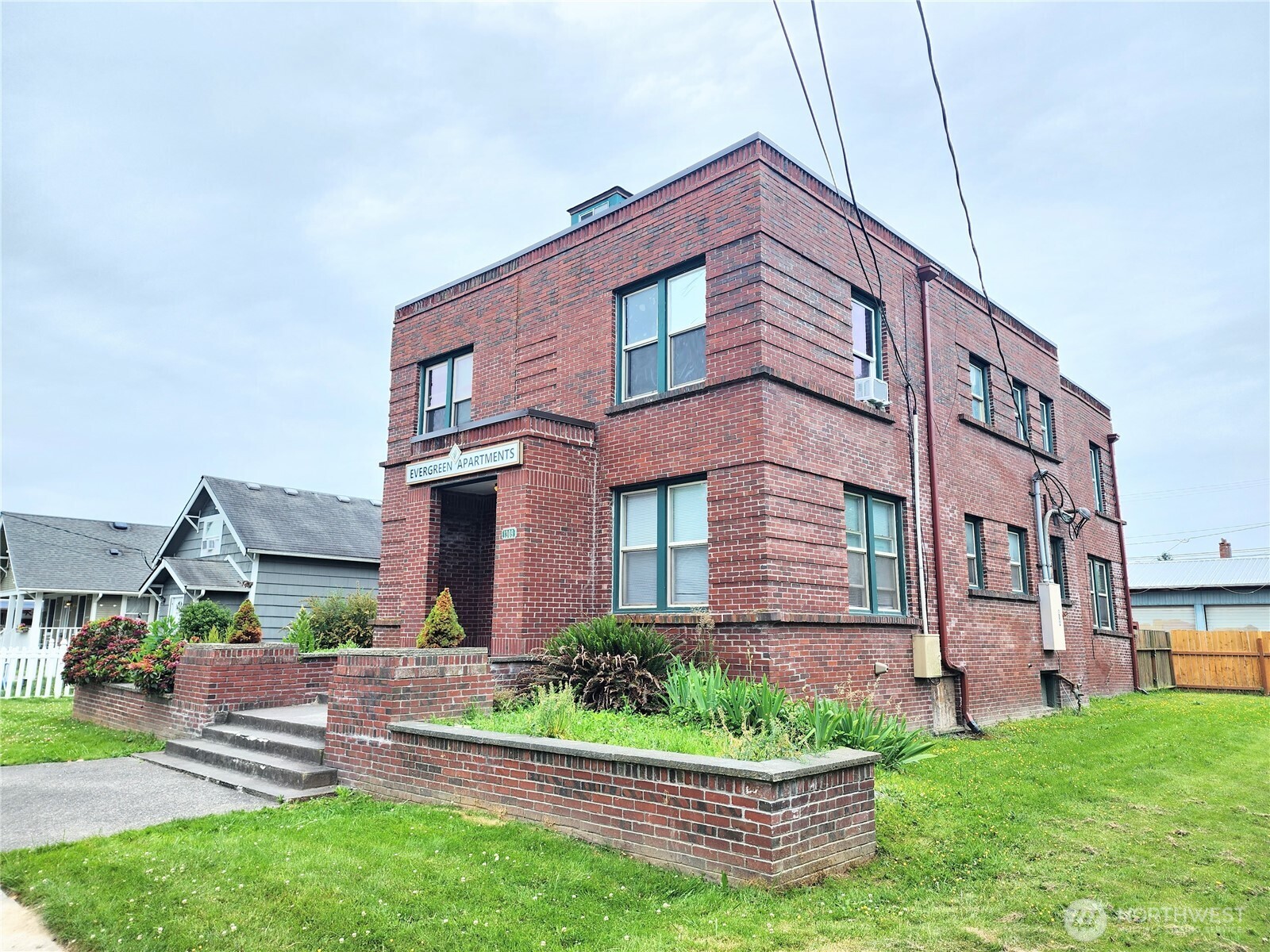 1309 South 3rd Street, Unit H Mount Vernon, WA 98273 - Photo 1 of 1 a front view of a house with a yard