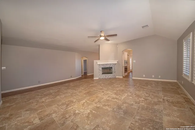 a view of empty room with a fireplace