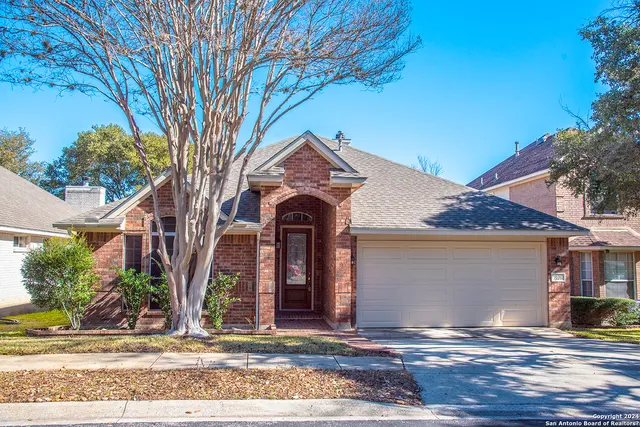 front view of a house with a tree