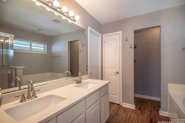 a bathroom with a sink double vanity and a mirror