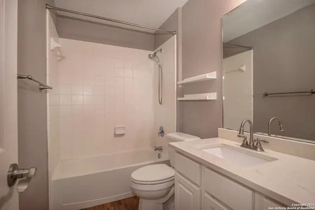 a bathroom with a sink toilet and shower