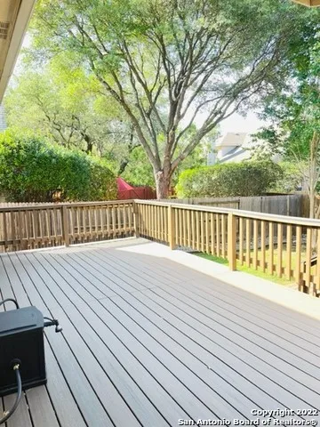 a view of deck with wooden floor and fence and floor to ceiling window