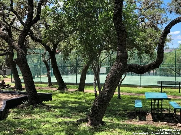 a backyard of a house with garden and outdoor seating