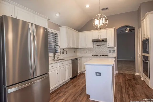 a kitchen with stainless steel appliances a refrigerator sink and stove