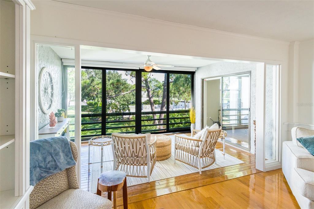 a living room with furniture and a large window with backyard view