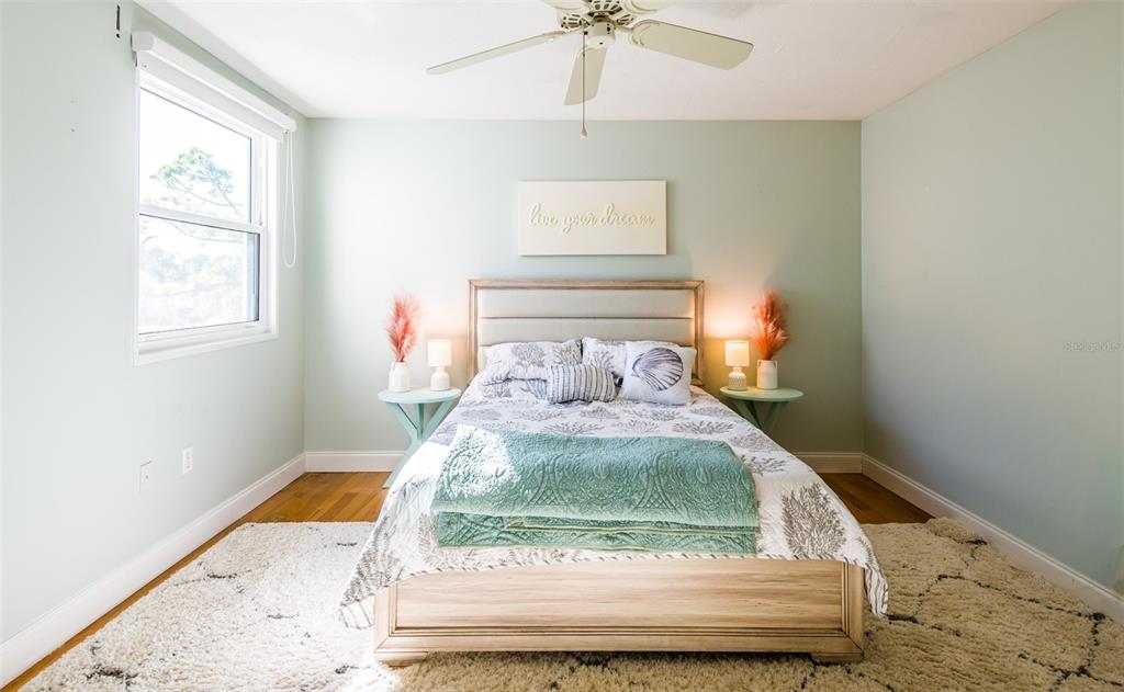 5014 Marsh Field Road, Unit 30 Sarasota, FL 34235 - Photo 5 of 9 a bed sitting in a bedroom next to a window