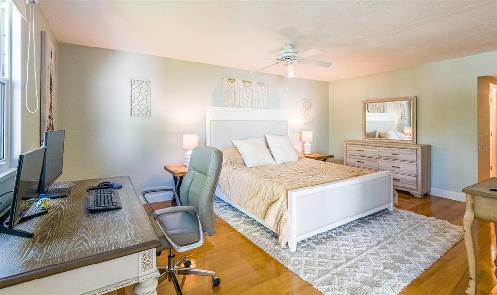 5014 Marsh Field Road, Unit 30 Sarasota, FL 34235 - Photo 6 of 9 a bedroom with a bed and wooden floor