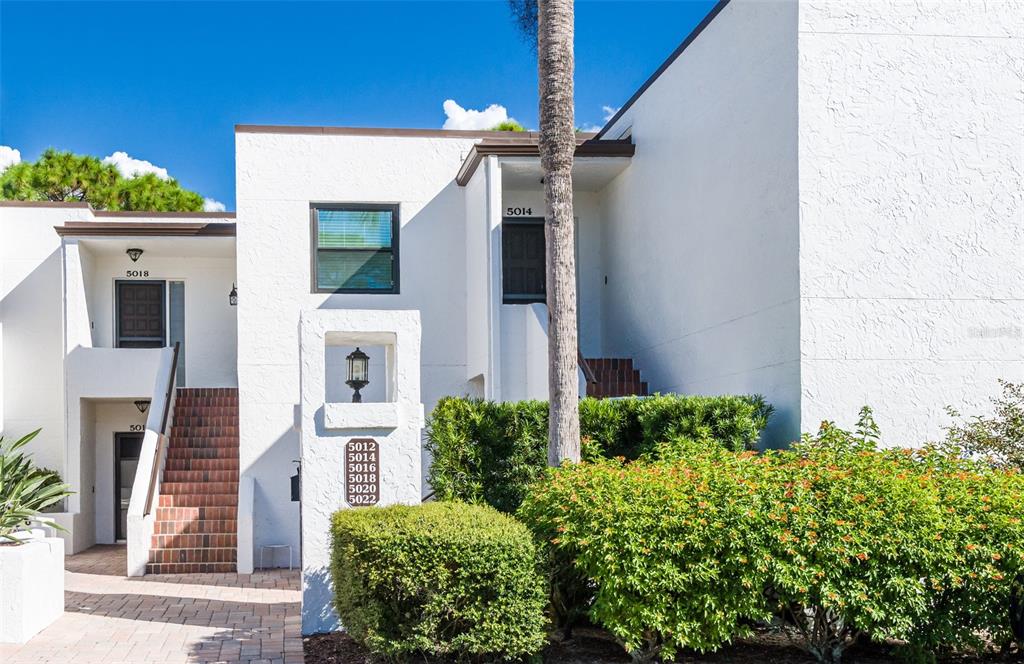 5014 Marsh Field Road, Unit 30 Sarasota, FL 34235 - Photo 8 of 9 a front view of a house with a yard